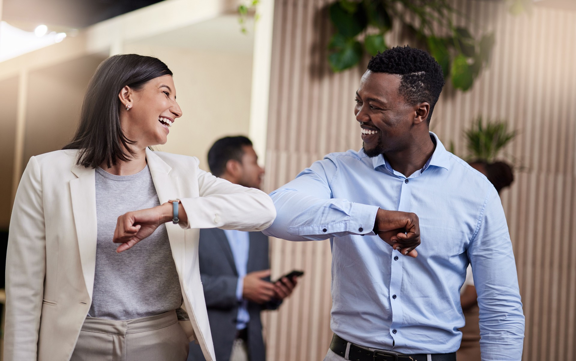 Shot of two business colleagues bumping elbows in a covid safe greeting